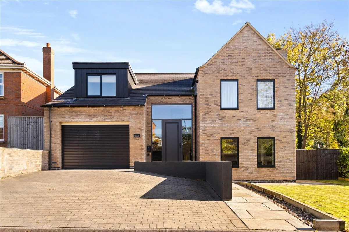 Modern brick house with a garage and block-paved driveway