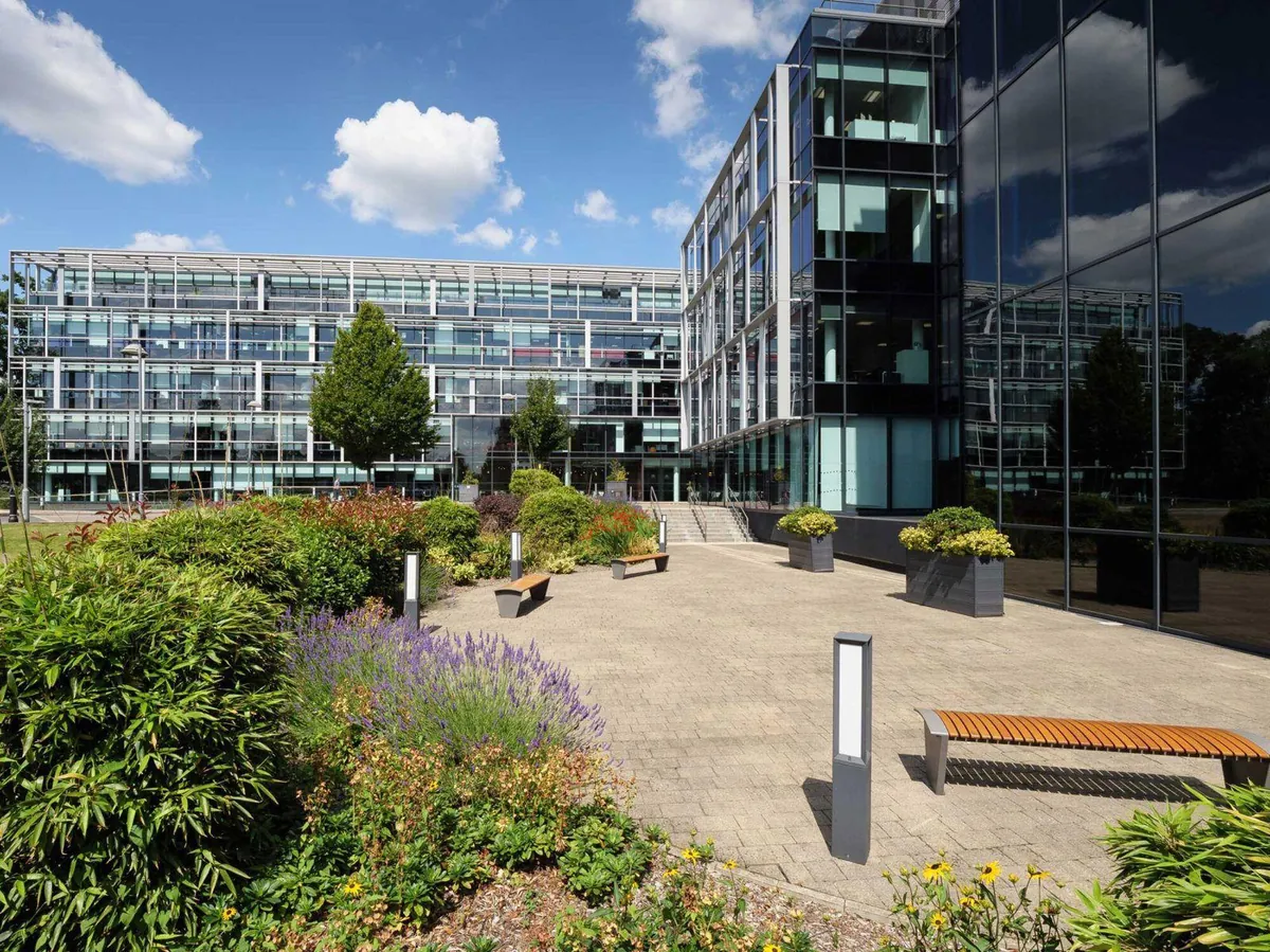 Landscaped courtyard between modern commercial buildings