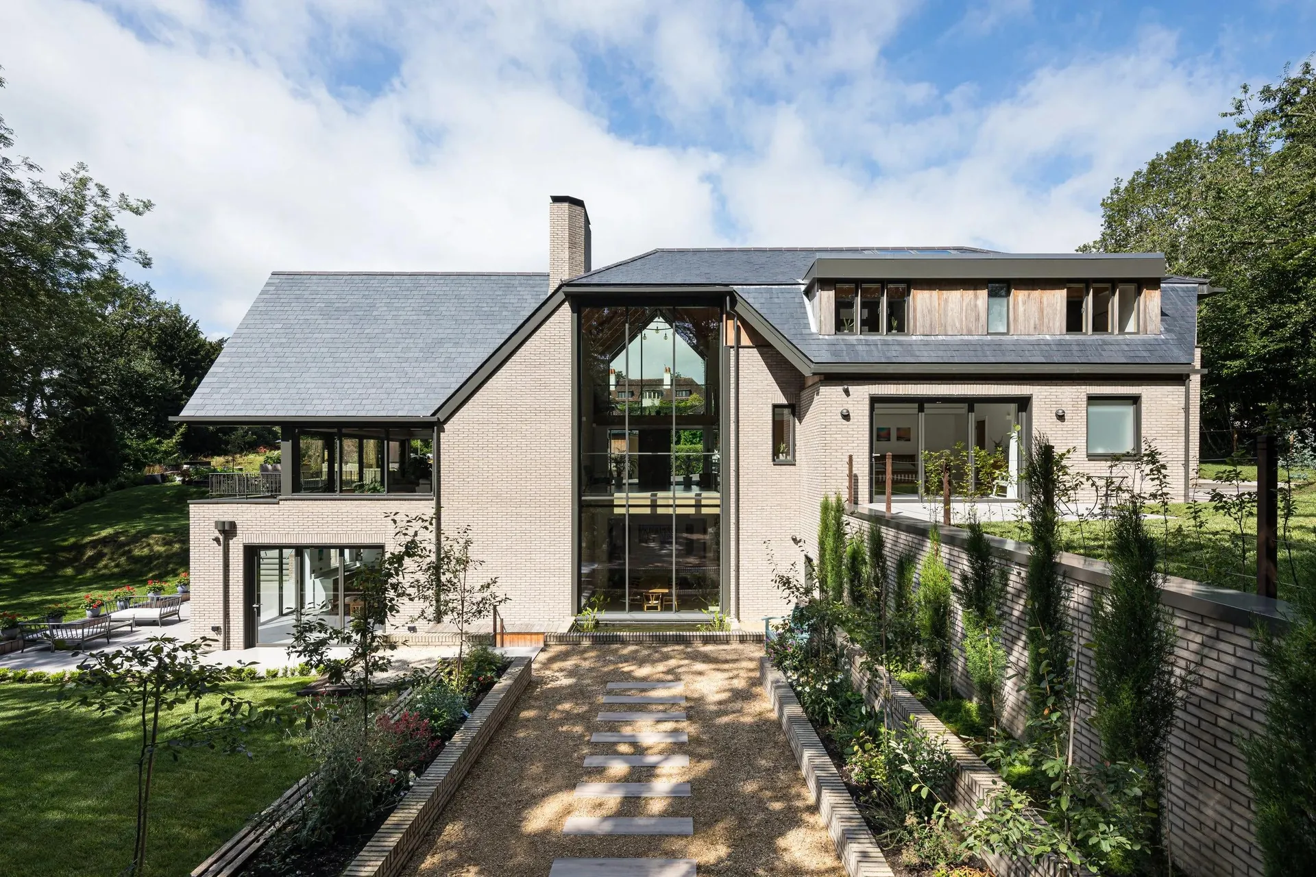 Contemporary British family home with a stone-paved approach and landscaped garden
