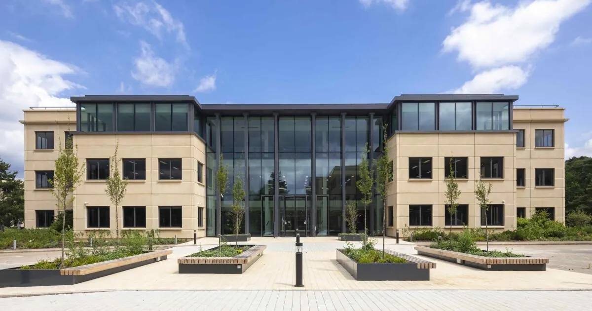 Three-storey office building with a landscaped forecourt